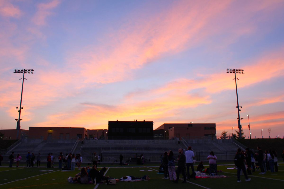 Seniors watch the sunrise at the stadium